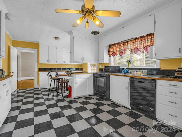 kitchen with ceiling fan, black appliances, ornamental molding, and white cabinets