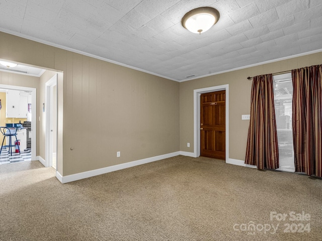 carpeted empty room with ornamental molding