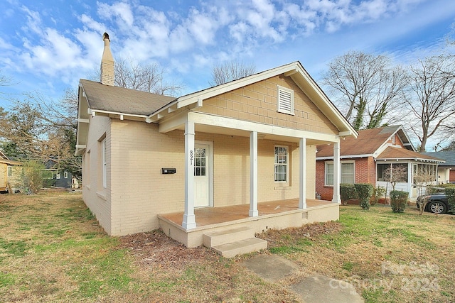 view of front facade with a front yard and a porch