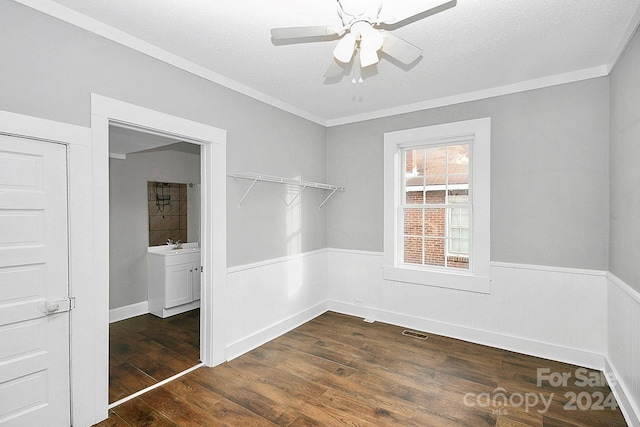 interior space featuring crown molding, a textured ceiling, ceiling fan, and dark hardwood / wood-style flooring