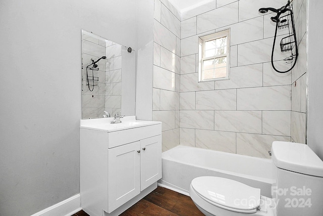 full bathroom featuring vanity, toilet, tiled shower / bath combo, and wood-type flooring