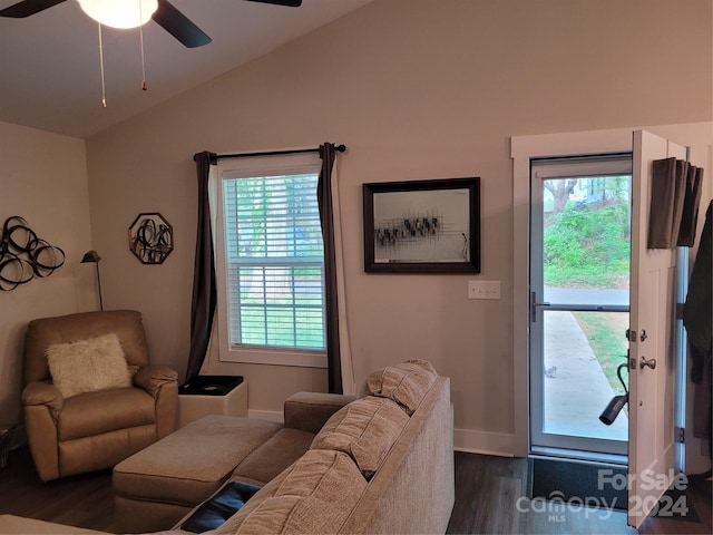 living room with a wealth of natural light, lofted ceiling, dark hardwood / wood-style floors, and ceiling fan