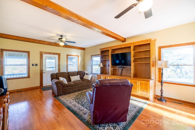 living room with ceiling fan, wood-type flooring, and a wealth of natural light