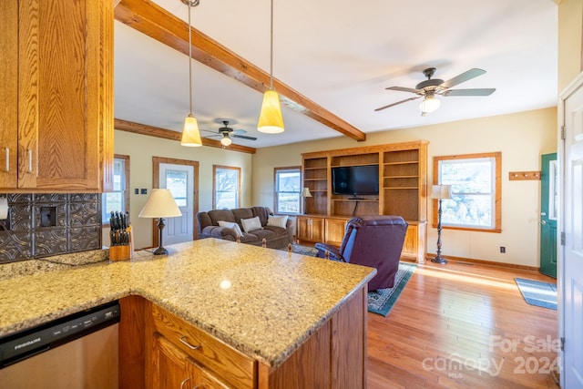 kitchen with dishwasher, beamed ceiling, hanging light fixtures, light hardwood / wood-style floors, and ceiling fan