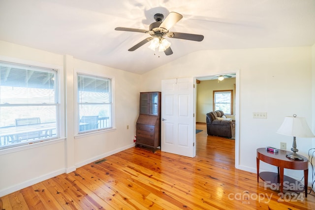 bedroom with ceiling fan, lofted ceiling, and light hardwood / wood-style flooring