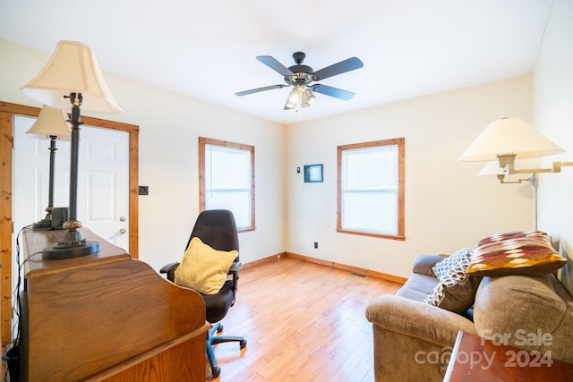 office with light hardwood / wood-style flooring and ceiling fan