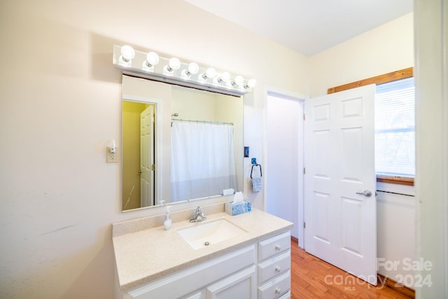 bathroom with vanity, wood-type flooring, and a shower with shower curtain