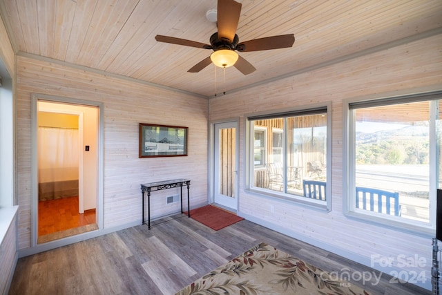 unfurnished sunroom with ceiling fan and wood ceiling