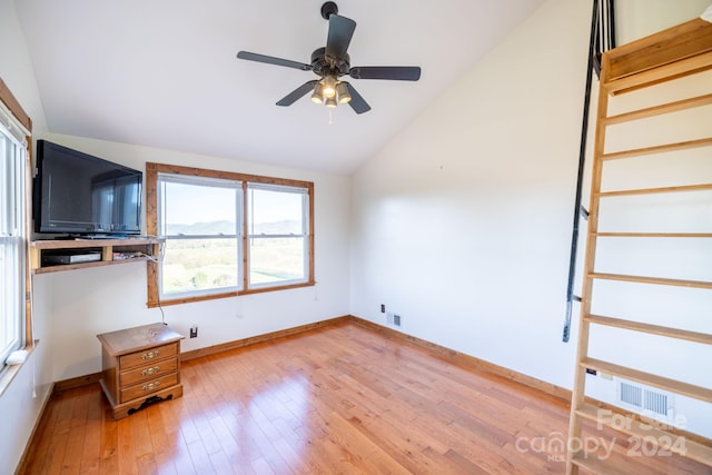 unfurnished living room with light hardwood / wood-style floors, vaulted ceiling, and ceiling fan