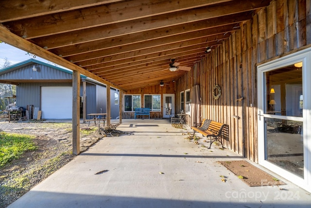 view of patio featuring an outbuilding, a garage, and ceiling fan