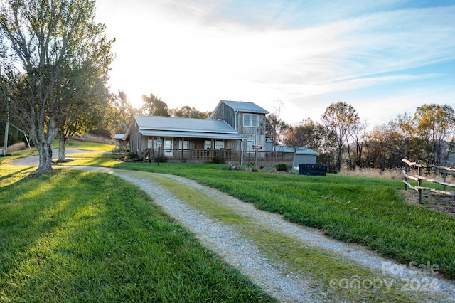 view of front of home with covered porch and a front lawn