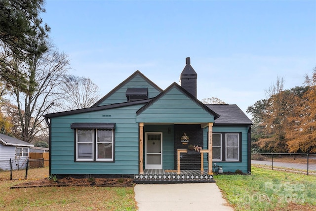 bungalow-style house featuring a front yard and covered porch