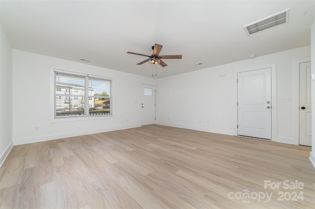 spare room featuring ceiling fan and light hardwood / wood-style flooring