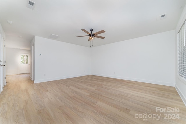 empty room with light hardwood / wood-style flooring and ceiling fan