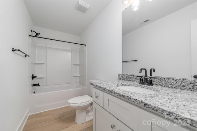 full bathroom featuring vanity, hardwood / wood-style flooring, toilet, and tub / shower combination