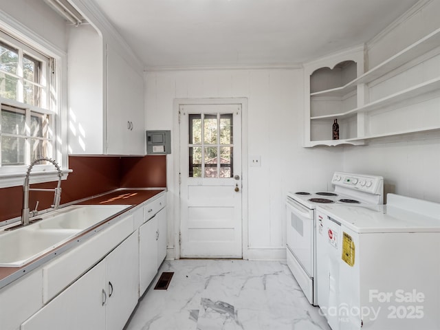 kitchen featuring plenty of natural light, electric range, marble finish floor, and a sink