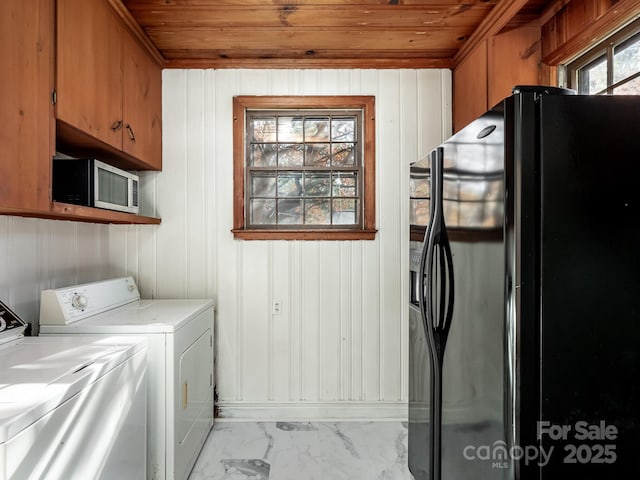 laundry area featuring cabinet space, wood ceiling, marble finish floor, and washing machine and clothes dryer