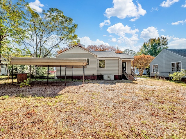 back of house featuring crawl space, a carport, and entry steps