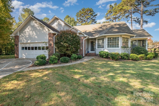 view of front of house with a front yard and a garage