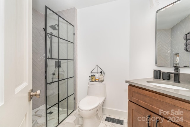 bathroom featuring vanity, toilet, tile patterned floors, and an enclosed shower