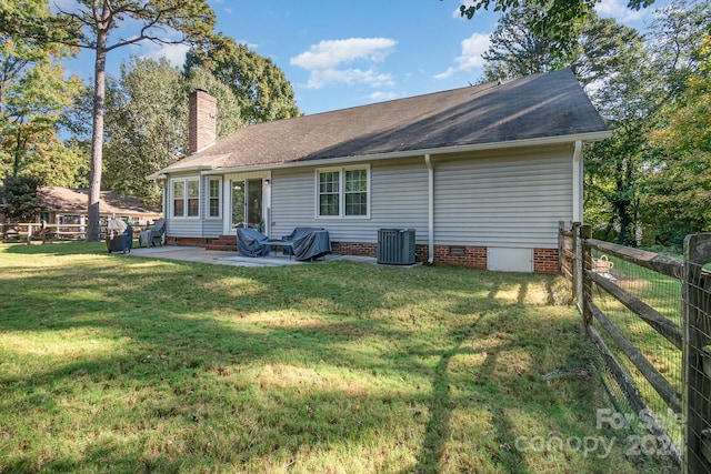 back of property featuring a patio, a lawn, and central air condition unit