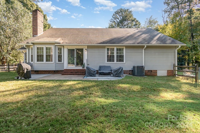 rear view of property featuring a yard, a patio area, and central AC unit