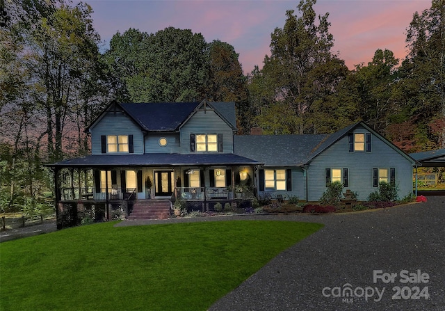 view of front facade featuring a porch and a lawn