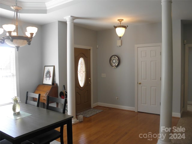 204 Par Dr, Henderson, NC 27536 - entryway featuring light wood finished floors, decorative columns, baseboards, a chandelier, and crown molding