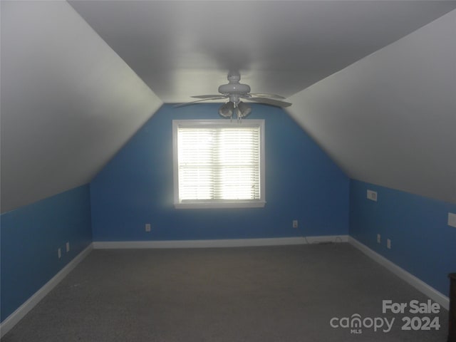 bonus room with ceiling fan, vaulted ceiling, and dark carpet