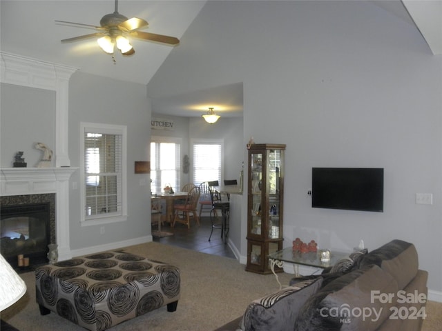 living room featuring carpet flooring, a premium fireplace, ceiling fan, and high vaulted ceiling