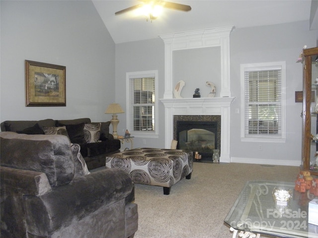 carpeted living room featuring a premium fireplace, ceiling fan, and lofted ceiling