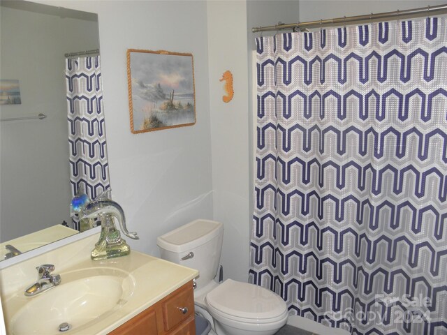 204 Par Dr, Henderson, NC 27536 - bathroom featuring vanity, toilet, and a shower with curtain