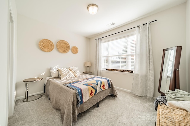 bedroom featuring light carpet