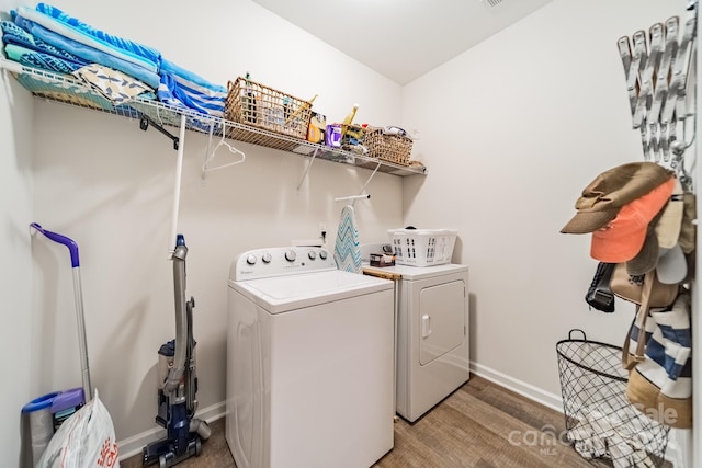 washroom with washer and dryer and wood-type flooring