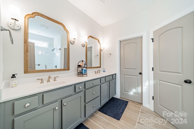 bathroom featuring a shower, vanity, and hardwood / wood-style flooring