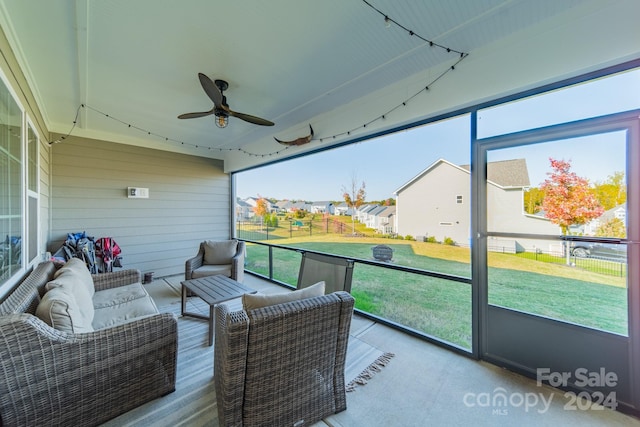 sunroom featuring ceiling fan and a wealth of natural light