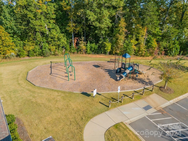 view of property's community featuring a yard and a playground