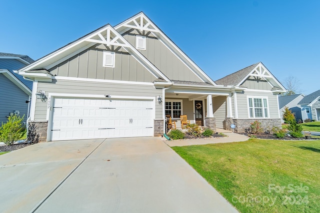 craftsman-style home with a porch and a front lawn