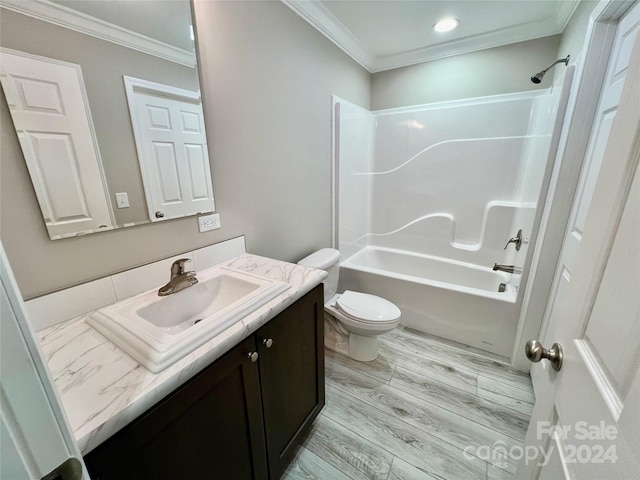 full bathroom featuring hardwood / wood-style floors, vanity, toilet, ornamental molding, and shower / bath combination