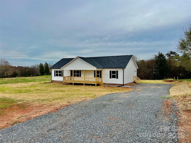 view of front of house featuring a shingled roof, a front yard, crawl space, and driveway