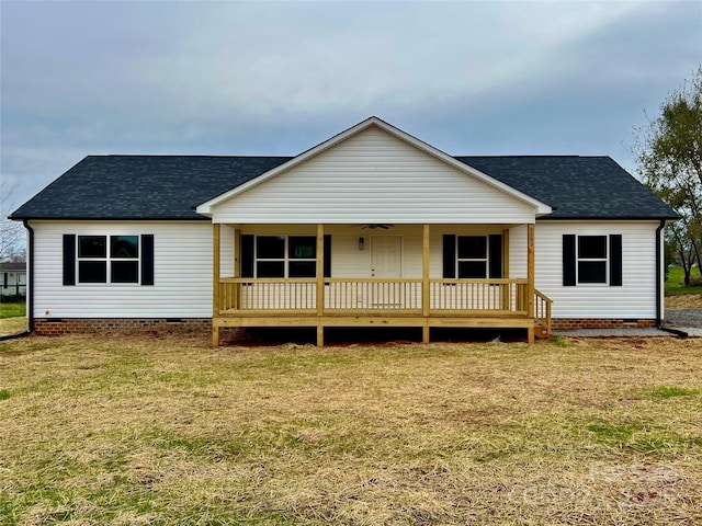 view of front of property with crawl space, roof with shingles, and a front lawn