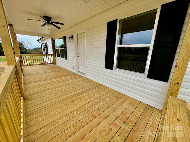 wooden deck with a porch and ceiling fan