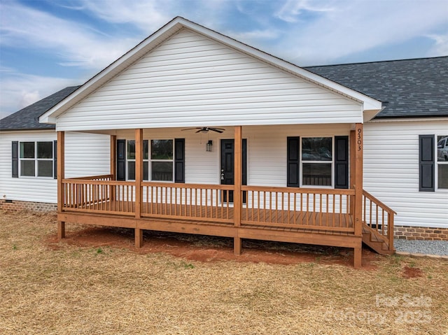 view of front of house featuring crawl space, covered porch, a shingled roof, and a ceiling fan