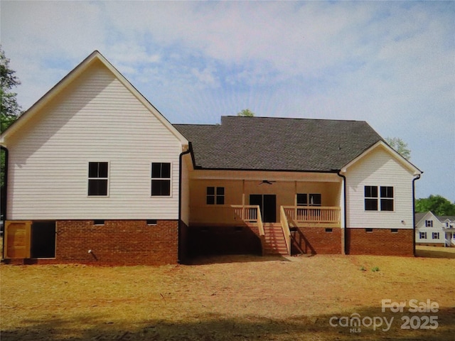 rear view of property featuring stairs, ceiling fan, and crawl space