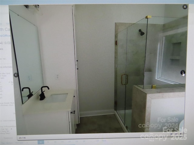 bathroom featuring a shower stall and vanity