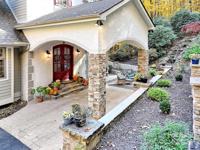 view of exterior entry with french doors and a patio