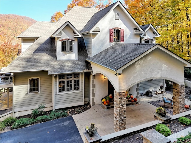 view of front of home featuring a patio area and a mountain view