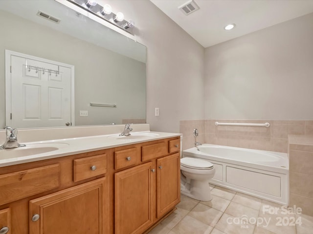 bathroom featuring vanity, toilet, a bath, and tile patterned floors