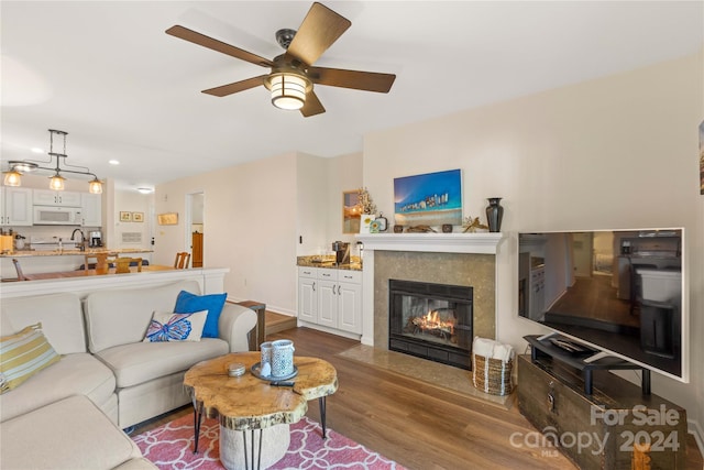 living room with dark hardwood / wood-style floors and ceiling fan