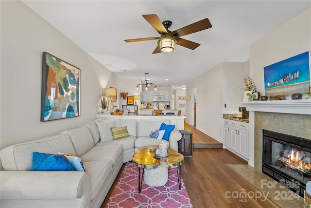 living room with hardwood / wood-style flooring and ceiling fan